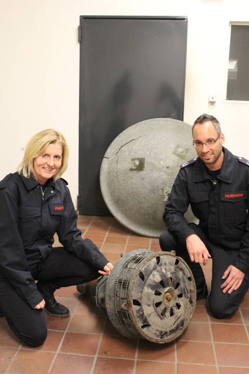  Nathalie Villière (Öffentlichkeitsarbeit Stadt Mettmann) und Marco Zerweiss, der stellvertretende Leiter der Mettmanner Feuerwehr zeigen eine alte und defekte Sirenenanlage. 