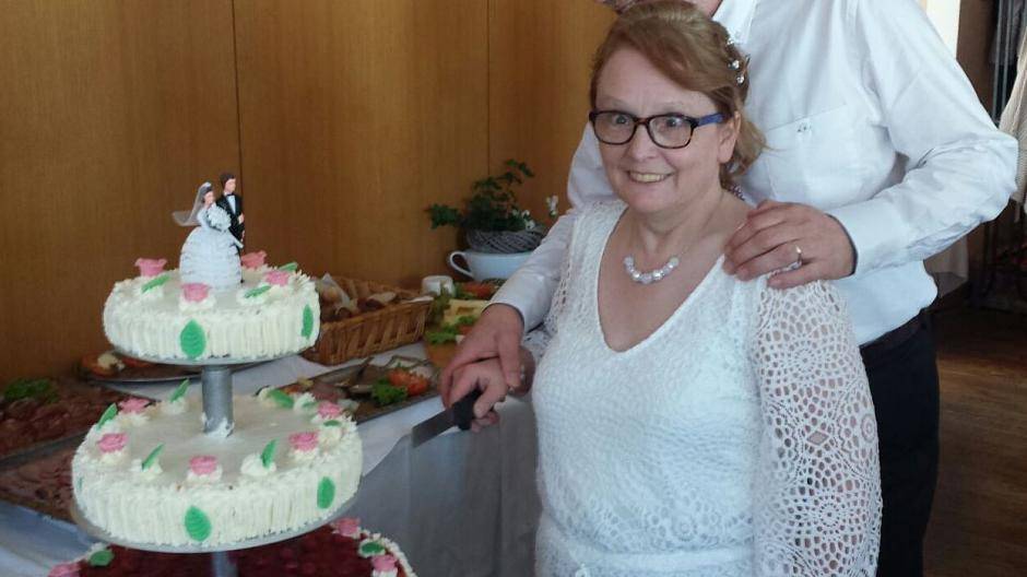 Angela und Reinhard Bernd-Striebeck beim Anschneiden der Hochzeitstorte im Haus...